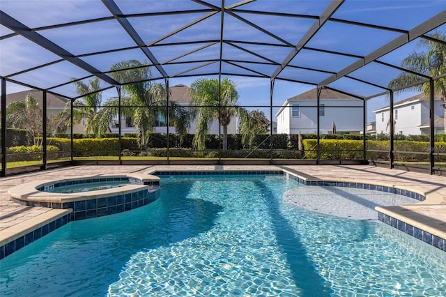 view of pool with a lanai, an in ground hot tub, cooling unit, and a patio