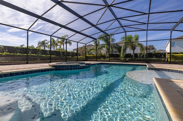 view of swimming pool featuring a lanai and an in ground hot tub