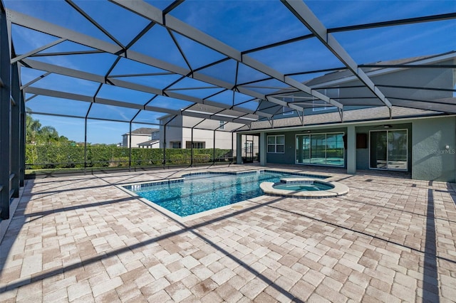 view of swimming pool featuring glass enclosure, an in ground hot tub, a patio area, and ceiling fan