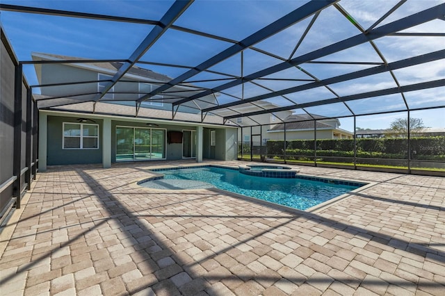 view of pool featuring an in ground hot tub, a patio, glass enclosure, and ceiling fan