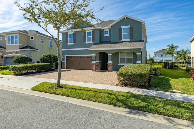 view of front of home featuring a garage and a front lawn