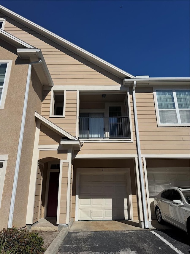 exterior space featuring a garage and a balcony