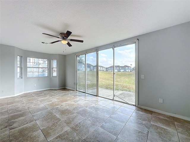 empty room featuring a textured ceiling and ceiling fan