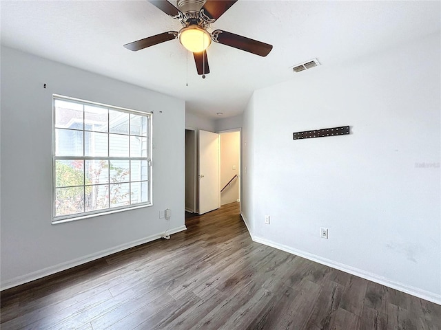 spare room featuring dark hardwood / wood-style flooring and ceiling fan