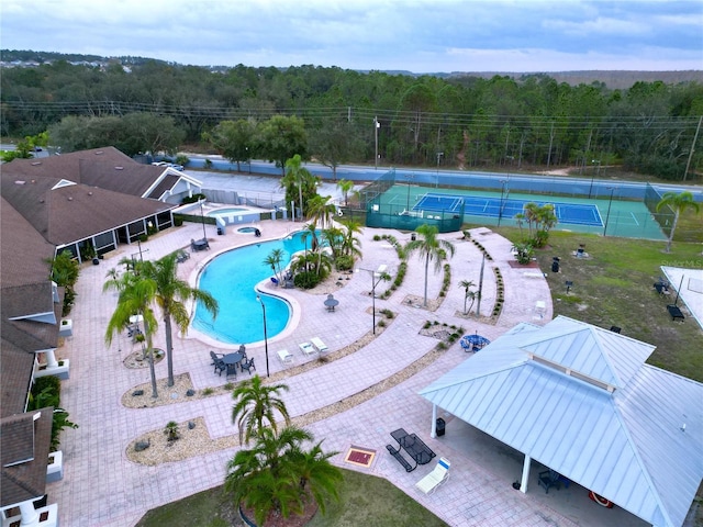 view of swimming pool with tennis court