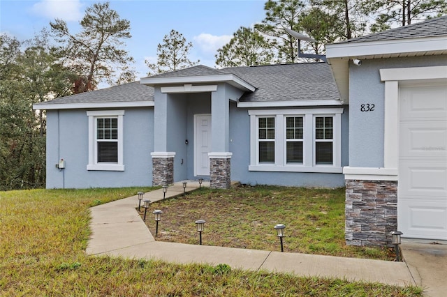 view of front of property with a garage and a front lawn