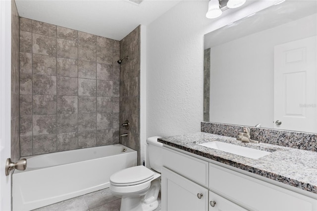 full bathroom featuring vanity, tile patterned floors, tiled shower / bath combo, and toilet