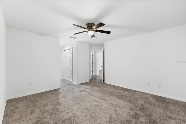 carpeted empty room featuring ceiling fan