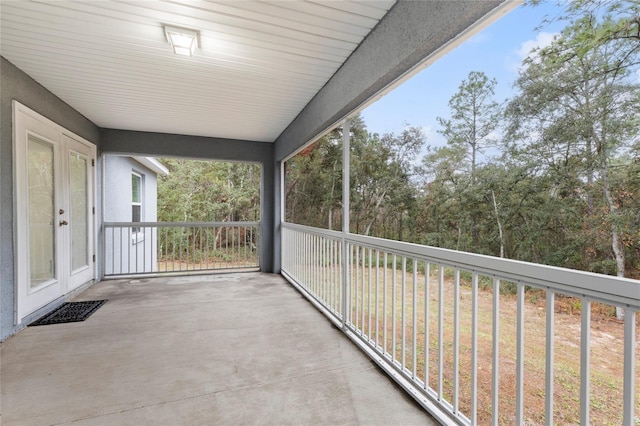 unfurnished sunroom with french doors