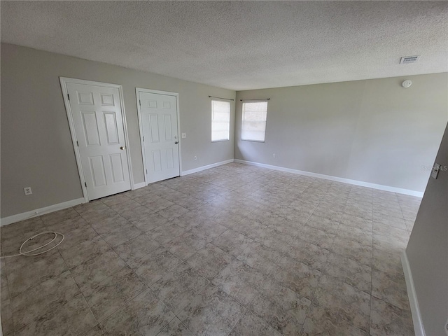 spare room with a textured ceiling