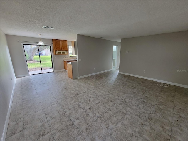 unfurnished living room with a textured ceiling