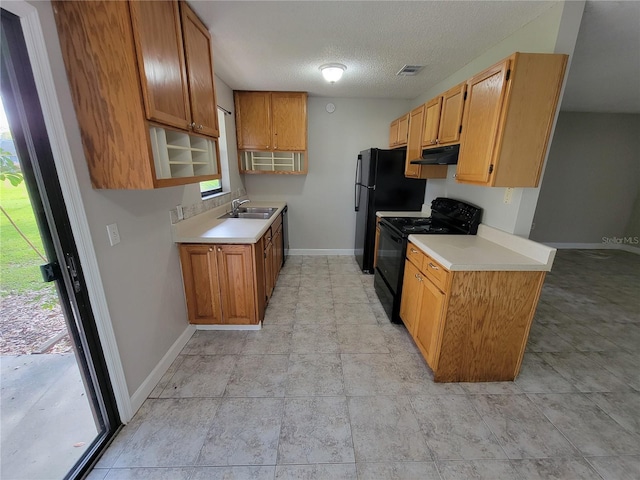 kitchen featuring black appliances, sink, and a textured ceiling