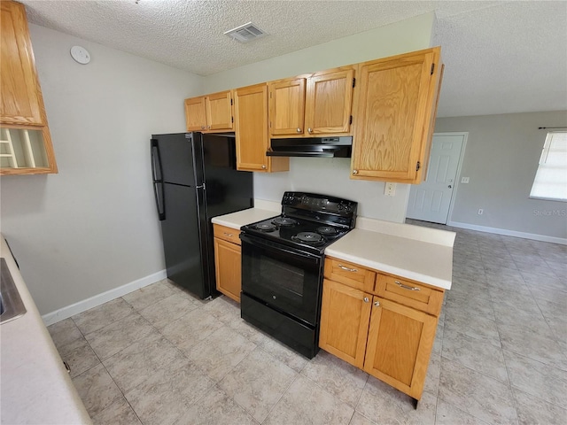 kitchen with black appliances and a textured ceiling