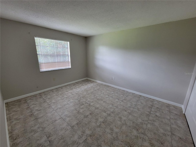 empty room with a textured ceiling