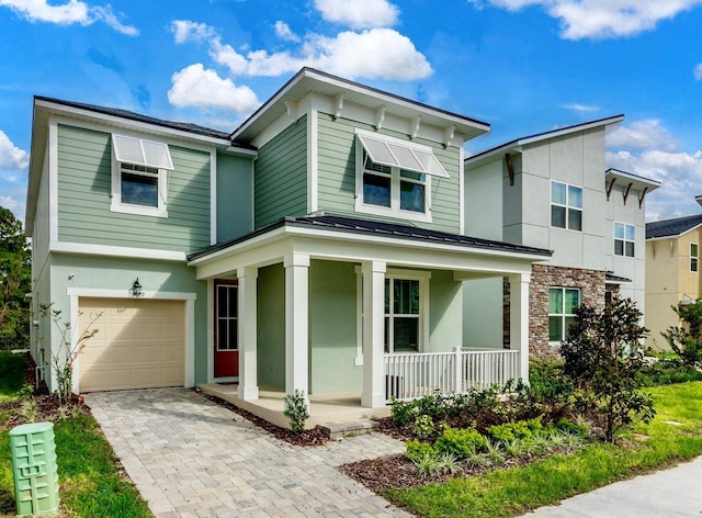 view of front of house featuring a porch and a garage