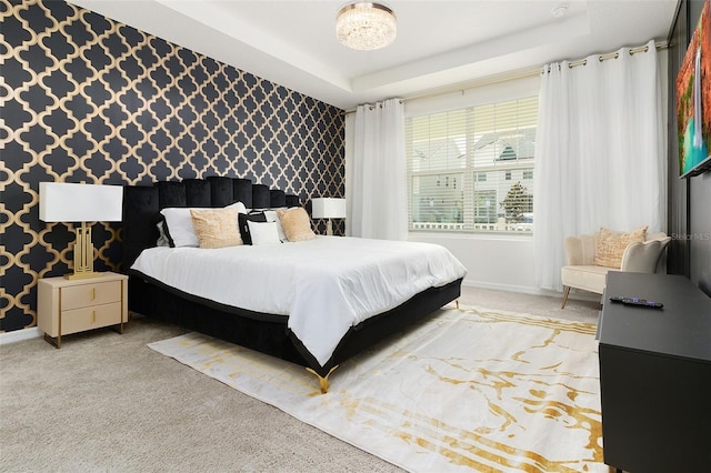 bedroom with carpet and a raised ceiling