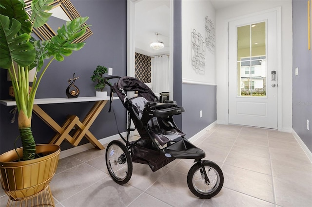 exercise room featuring light tile patterned flooring