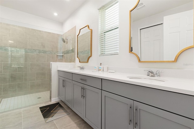 bathroom featuring tile patterned floors, vanity, and tiled shower