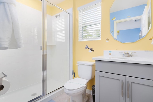 bathroom featuring vanity, toilet, and an enclosed shower