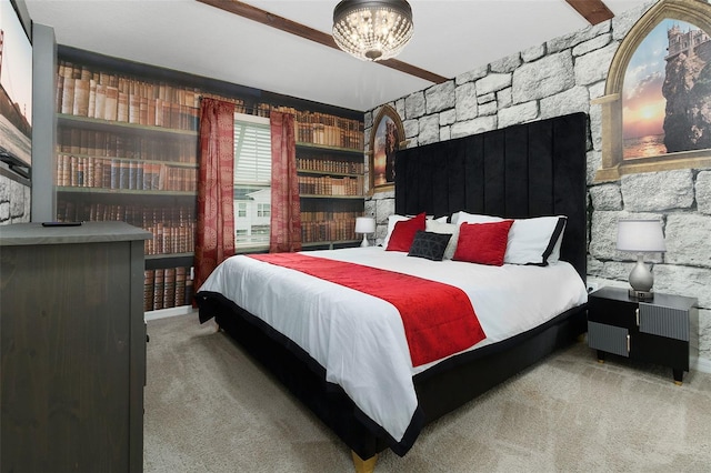 carpeted bedroom featuring beamed ceiling