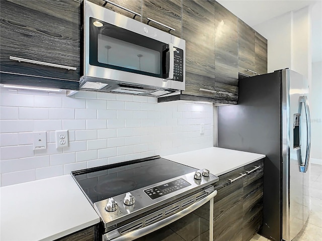 kitchen with backsplash, dark brown cabinetry, and stainless steel appliances