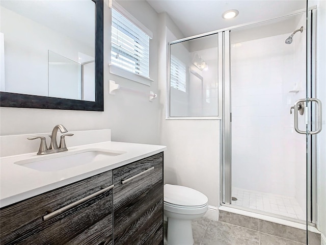 bathroom with tile patterned floors, vanity, toilet, and walk in shower