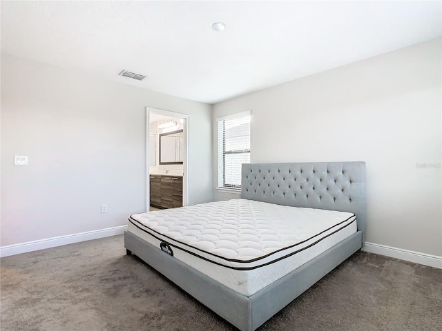 carpeted bedroom featuring ensuite bath