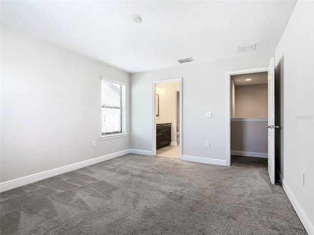 unfurnished bedroom with light colored carpet and ensuite bath