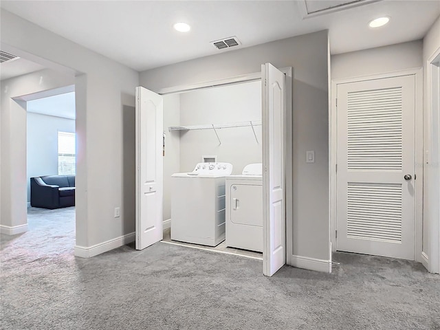 laundry area with washing machine and clothes dryer and carpet