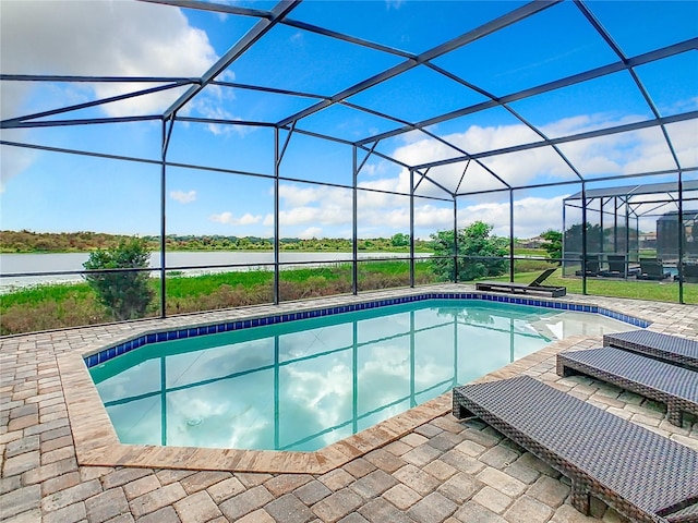 view of swimming pool featuring a patio and a lanai