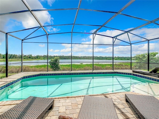 view of pool with a lanai and a water view