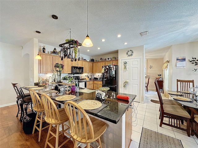 tiled dining space featuring a textured ceiling