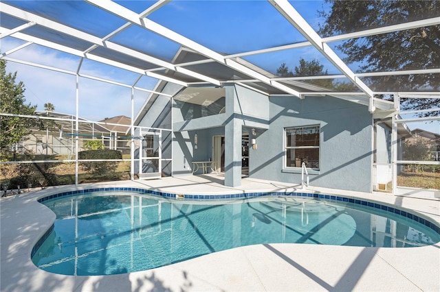 view of pool with a patio area and a lanai