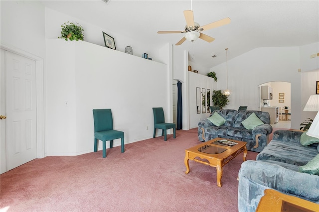 carpeted living room with high vaulted ceiling and ceiling fan