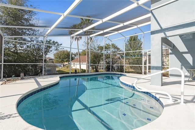 view of swimming pool featuring a lanai and a patio area