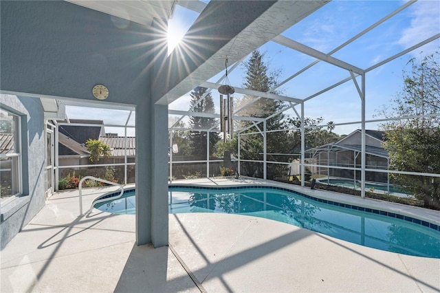 view of swimming pool with a jacuzzi, a lanai, and a patio