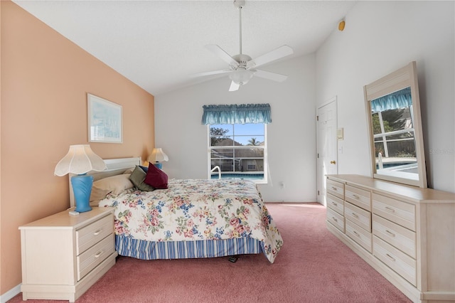 carpeted bedroom with access to outside, ceiling fan, and vaulted ceiling