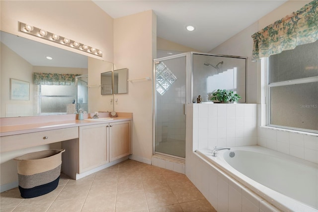 bathroom with tile patterned floors, vanity, and shower with separate bathtub