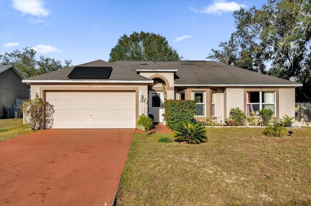 single story home with a front yard, solar panels, a garage, and central air condition unit