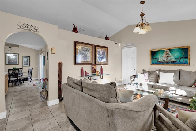 tiled living room featuring a chandelier and vaulted ceiling