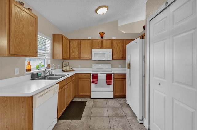 kitchen with a textured ceiling, white appliances, sink, lofted ceiling, and light tile patterned flooring