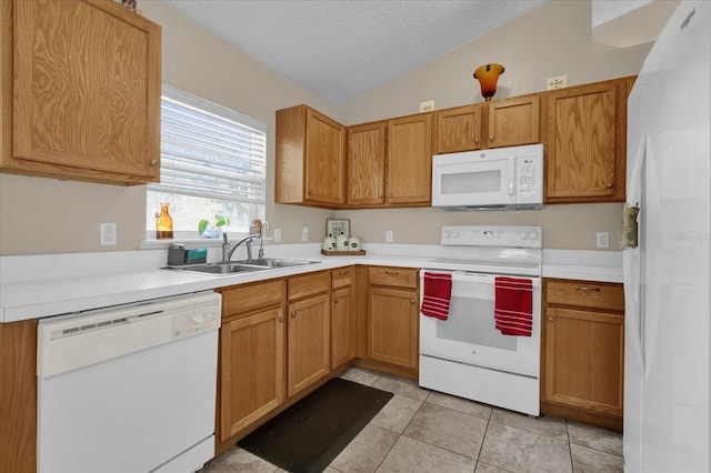 kitchen featuring sink, vaulted ceiling, a textured ceiling, white appliances, and light tile patterned floors