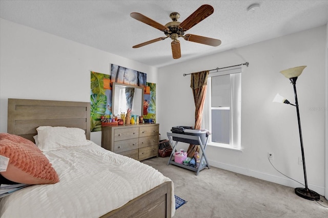 carpeted bedroom with a textured ceiling and ceiling fan