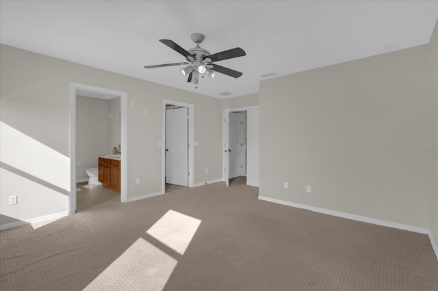 unfurnished bedroom with ensuite bath, ceiling fan, and light carpet