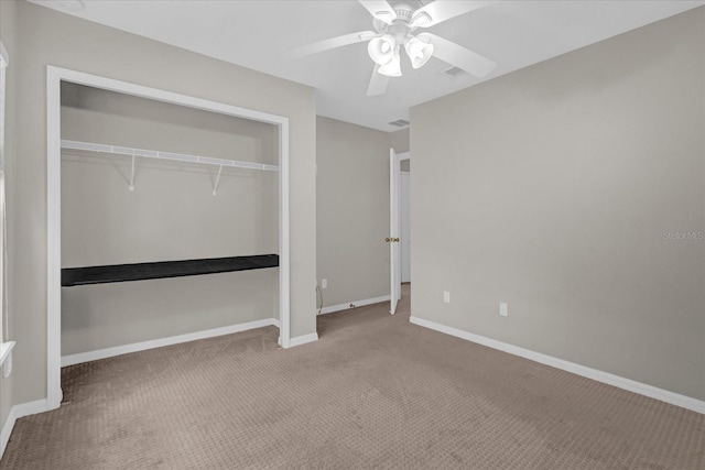 unfurnished bedroom featuring visible vents, a closet, carpet, baseboards, and ceiling fan