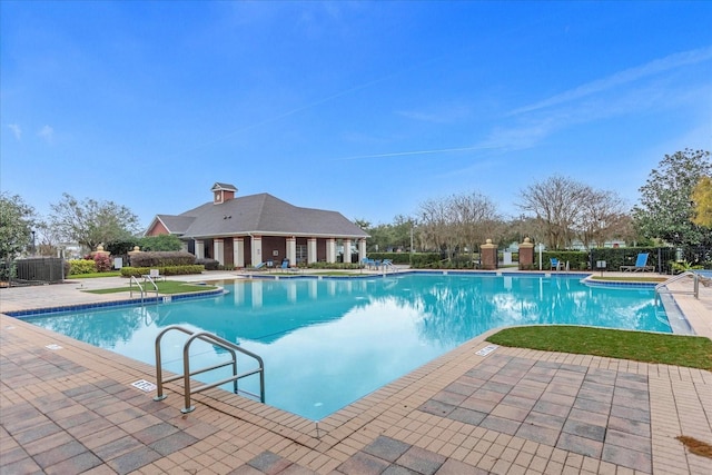 community pool featuring a patio and fence