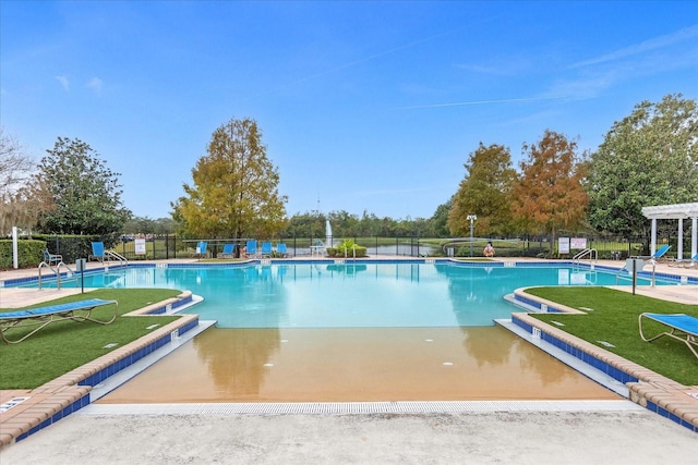 view of pool featuring a pergola and a lawn