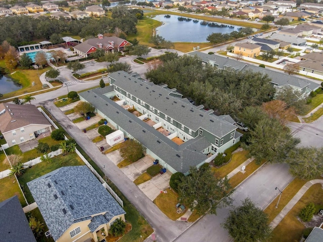 drone / aerial view featuring a water view and a residential view