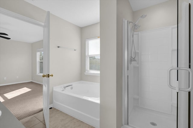 bathroom featuring baseboards, a stall shower, ceiling fan, tile patterned flooring, and a bath