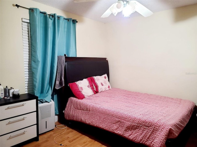 bedroom with ceiling fan and light hardwood / wood-style flooring